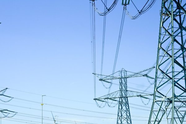 High-voltage electricity towers along the highway.